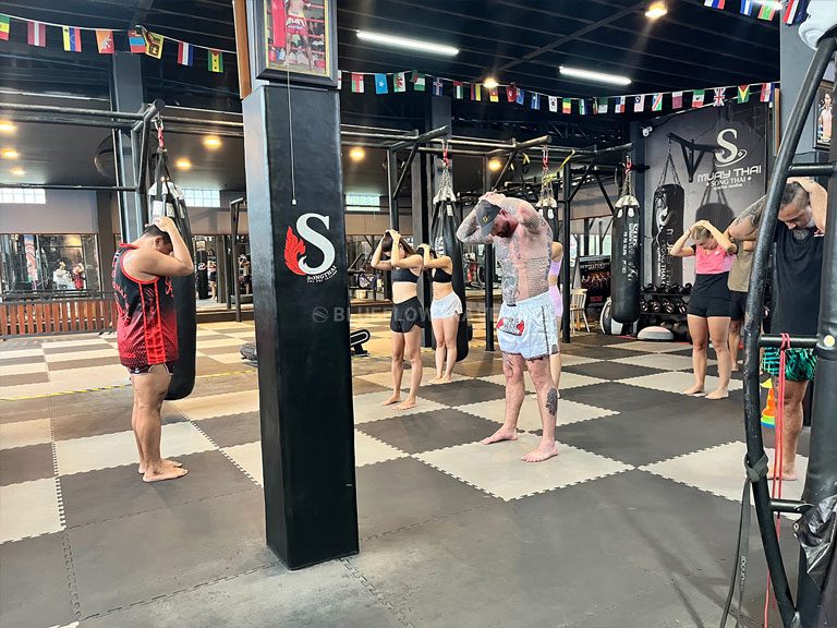 Students practising Muay Thai techniques during a group class in Koh Phi Phi