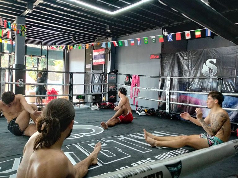 Muay Thai students warming up and stretching before training in Koh Phi Phi